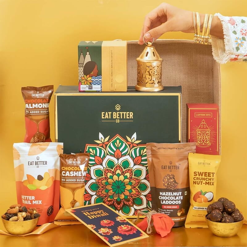 Eat Better Co Prakriti Diwali Gift Hamper with Jute Tray - 10 Item Gift Pack - Dry Fruits Laddoo, Chocolate Coated Nuts with Phool Incense Cones & Lanten Diya | Diwali Gift Box for Friends & Family