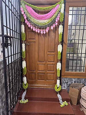 Cloth garland door set with brass diya