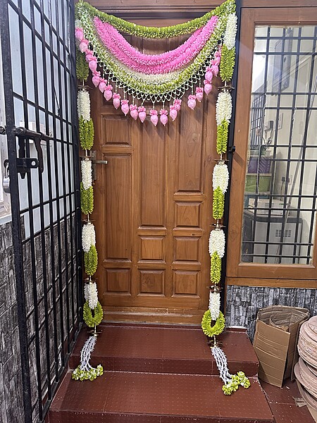 Cloth garland door set with brass diya