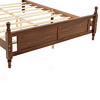 vintage-style wooden bed with an upholstered headboard