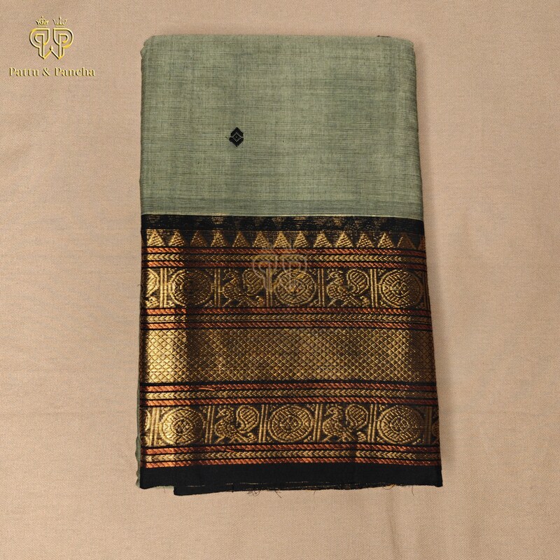 Kanchi Cotton Pastel Mint Green saree with black Buttas and zari border.