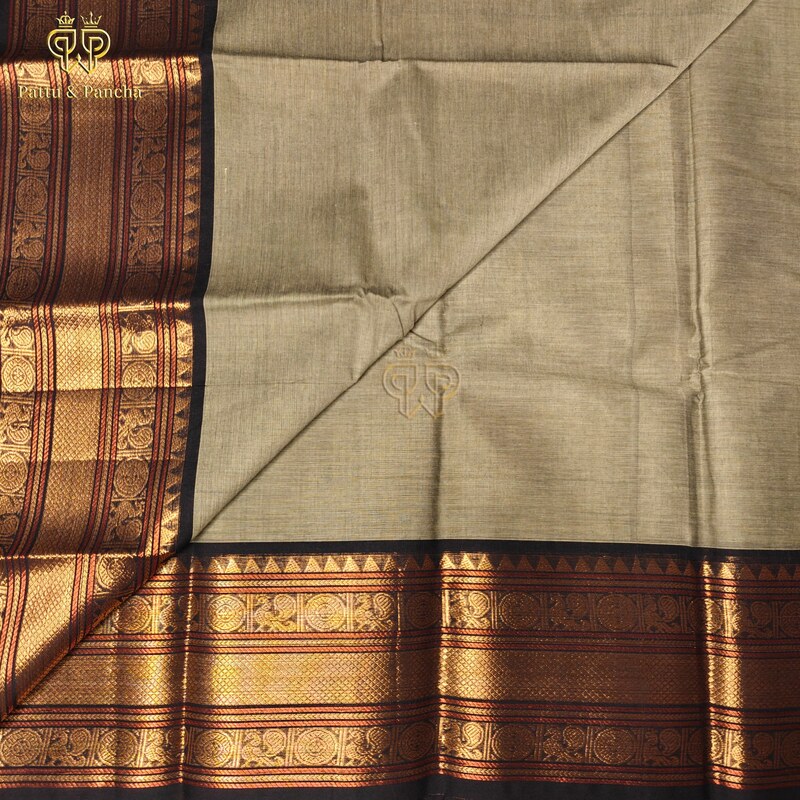 Kanchi Cotton Pastel Mint Green saree with black Buttas and zari border.