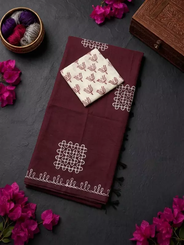 Dark brown cotton saree featuring simple white Rangoli prints across the body
