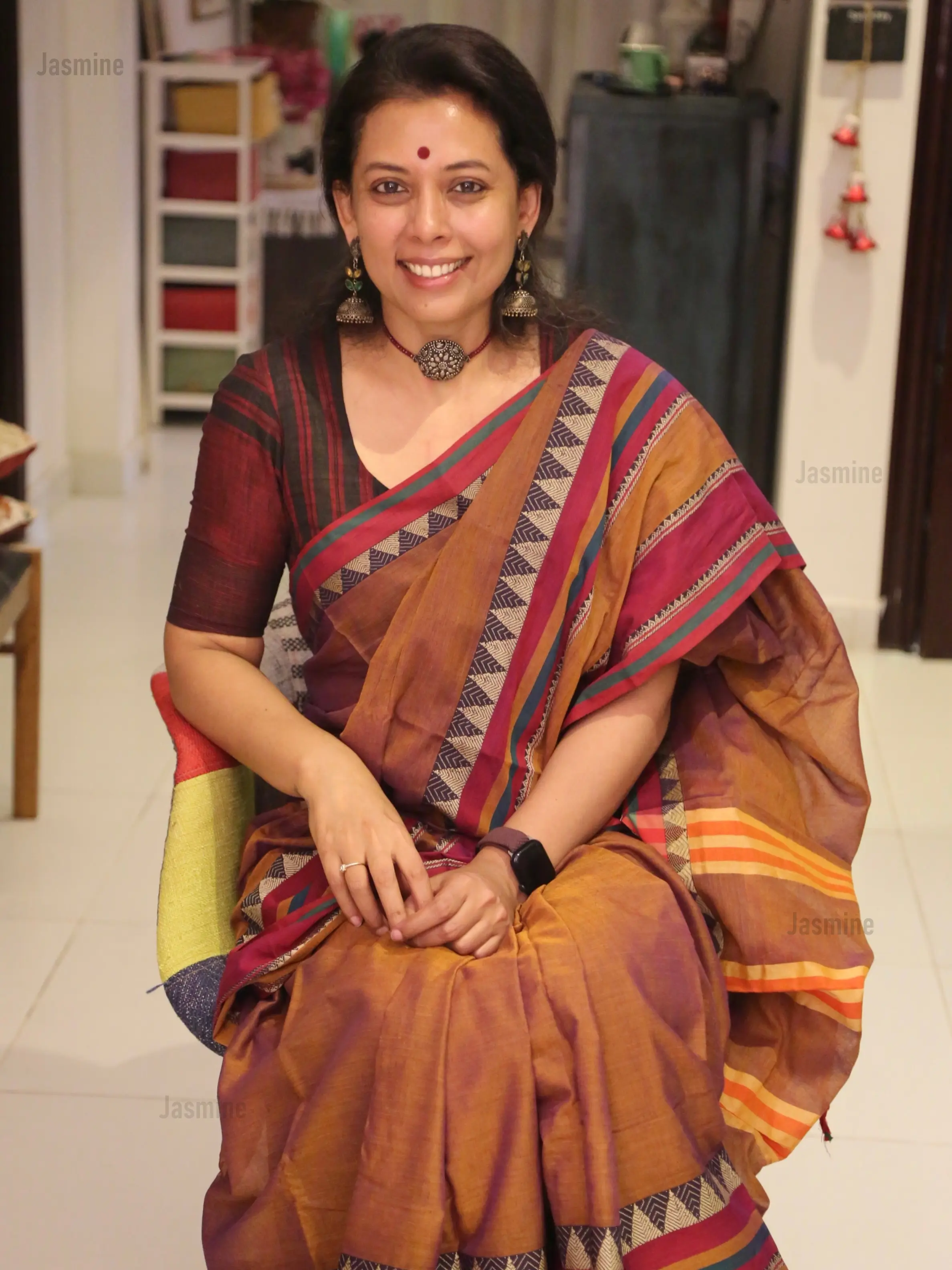 Terracotta dual-shade cotton saree featuring a distinctive spike-style temple border