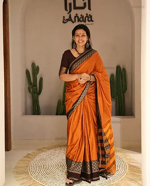 orange Narayanpet cotton saree with dark brown floral border