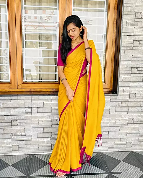 Soft yellow cotton saree with delicate pink border