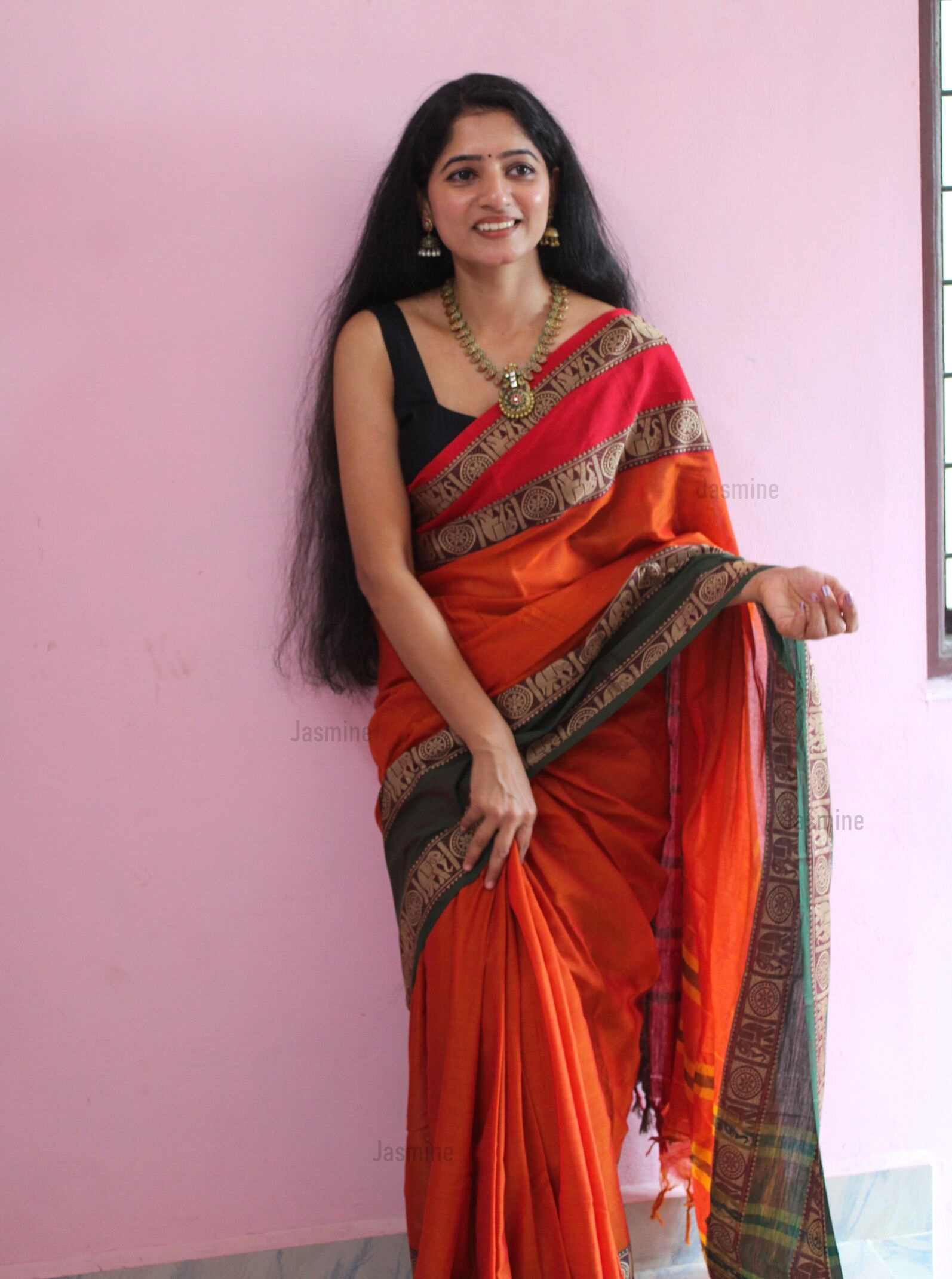 Orange handloom cotton saree with contrasting green and red borders