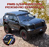 FMS Model 1: 10 Canyon RS Black front angle view with LED headlights illuminated