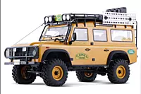 FMS Model 1: 10 FCX10 Land Rover Defender RS Yellow front angle view on rock trail