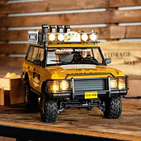 Illuminated LED headlights and taillights on FMS FCX10 Range Rover RS Yellow outdoor