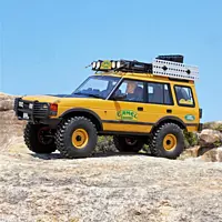 FMS Model 1:10 Land Rover Discovery RS Yellow climbing over steep rocks