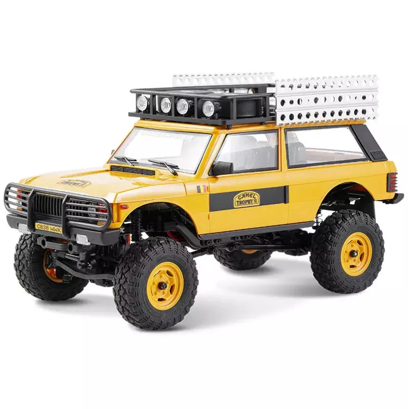 FMS Model 1: 24 Range Rover 1st- Generation RTR Yellow front angle view on rock obstacle