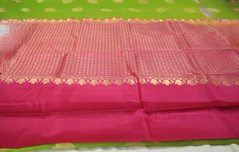 Green silk saree with pink zari pallu and subtle zari border