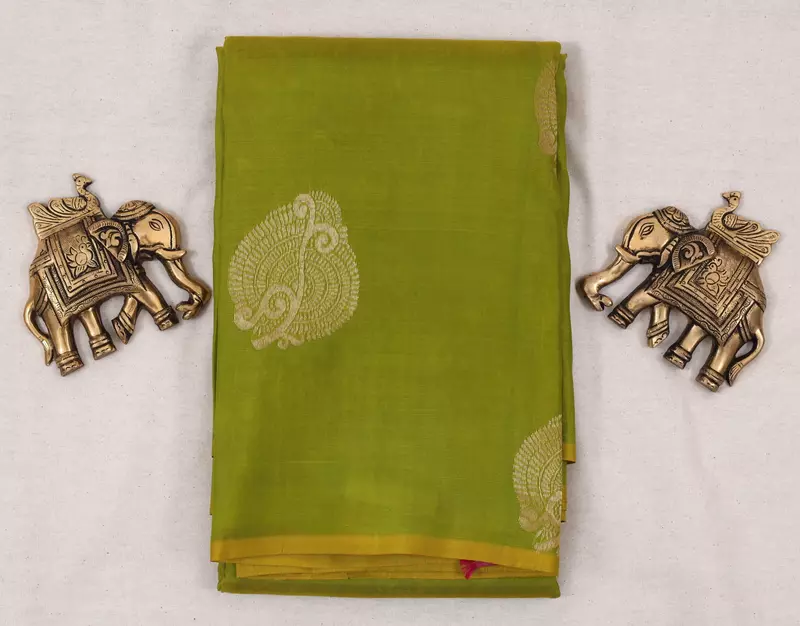Green silk saree with pink zari pallu and subtle zari border