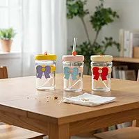 Tumblers With Bow-Shaped Silicone Sleeves and Lids.