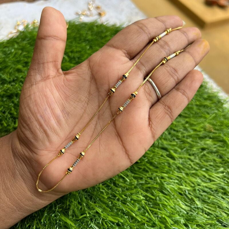 Trendy daily wear gold chain with black ball and white enamel design