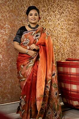 Rust Orange color pure Mulberry silk with flower hand batik motif saree from our Mystic Radainave collection