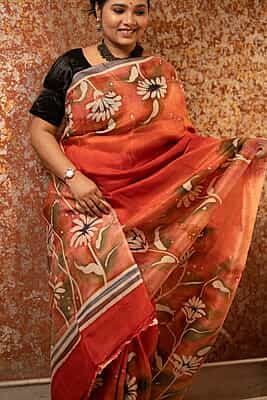 Rust Orange color pure Mulberry silk with flower hand batik motif saree from our Mystic Radainave collection