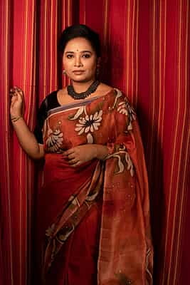 Rust Orange color pure Mulberry silk with flower hand batik motif saree from our Mystic Radainave collection