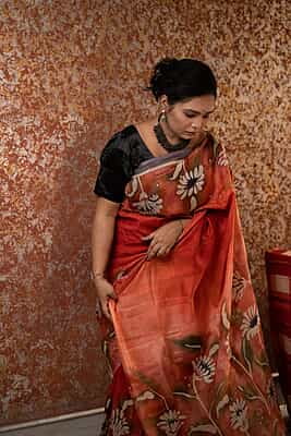 Rust Orange color pure Mulberry silk with flower hand batik motif saree from our Mystic Radainave collection