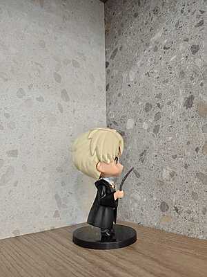 Draco Malfoy holding his wand