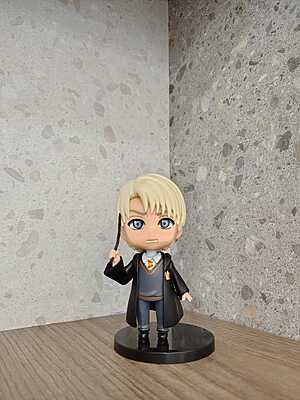 Draco Malfoy holding his wand