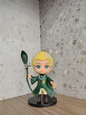 Draco Malfoy holding his  wand