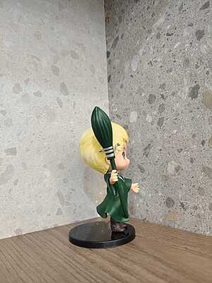 Draco Malfoy holding his  wand