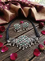oxidized silver choker set combines traditional ethnic motifs with pastel accents: