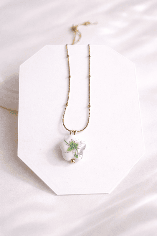 Delicate gold necklace with porcelain flower