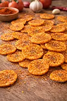 Close up of crispy tomato flavoured banana chips