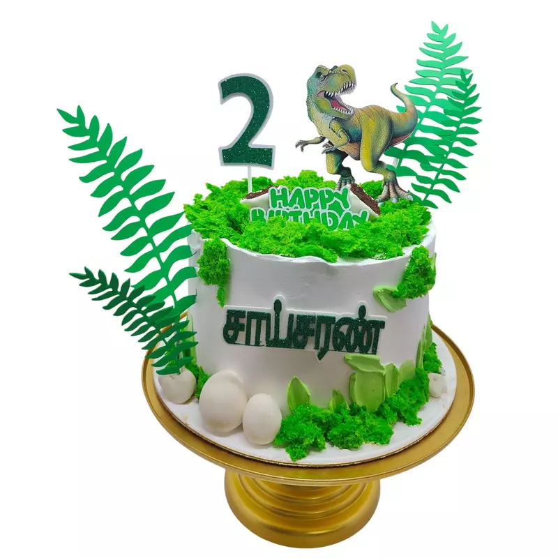 white and green themed dinosaur birthday cake