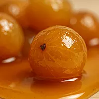 Close-up texture of pure honey amla with glossy natural coating