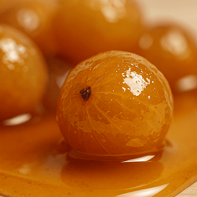 Close-up texture of pure honey amla with glossy natural coating