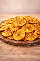 Texture of Kerala spicy banana chips with masala coating