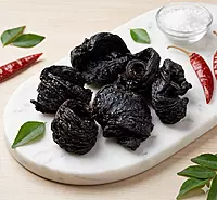 Close-up of sun-dried de-seeded kudampuli showing natural Malabar tamarind texture