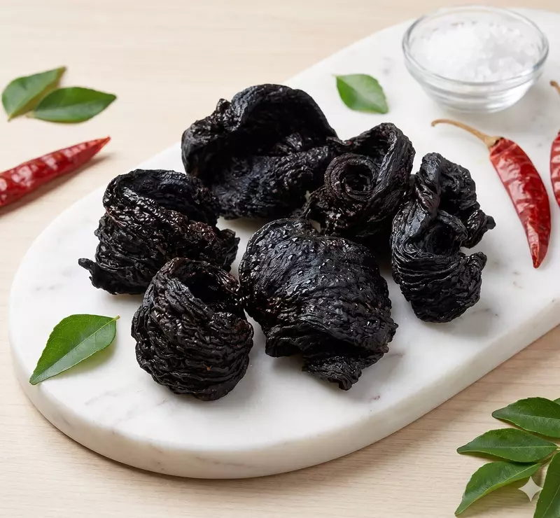 Close-up of sun-dried de-seeded kudampuli showing natural Malabar tamarind texture