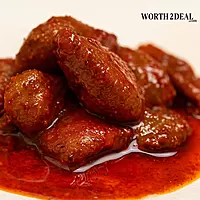 Close-up of tender mango pieces in spicy sesame oil Kerala pickle